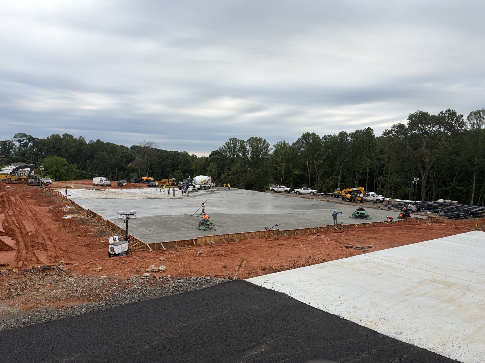 Crew finishing a large concrete slab pour on an Oxen Civil construction site