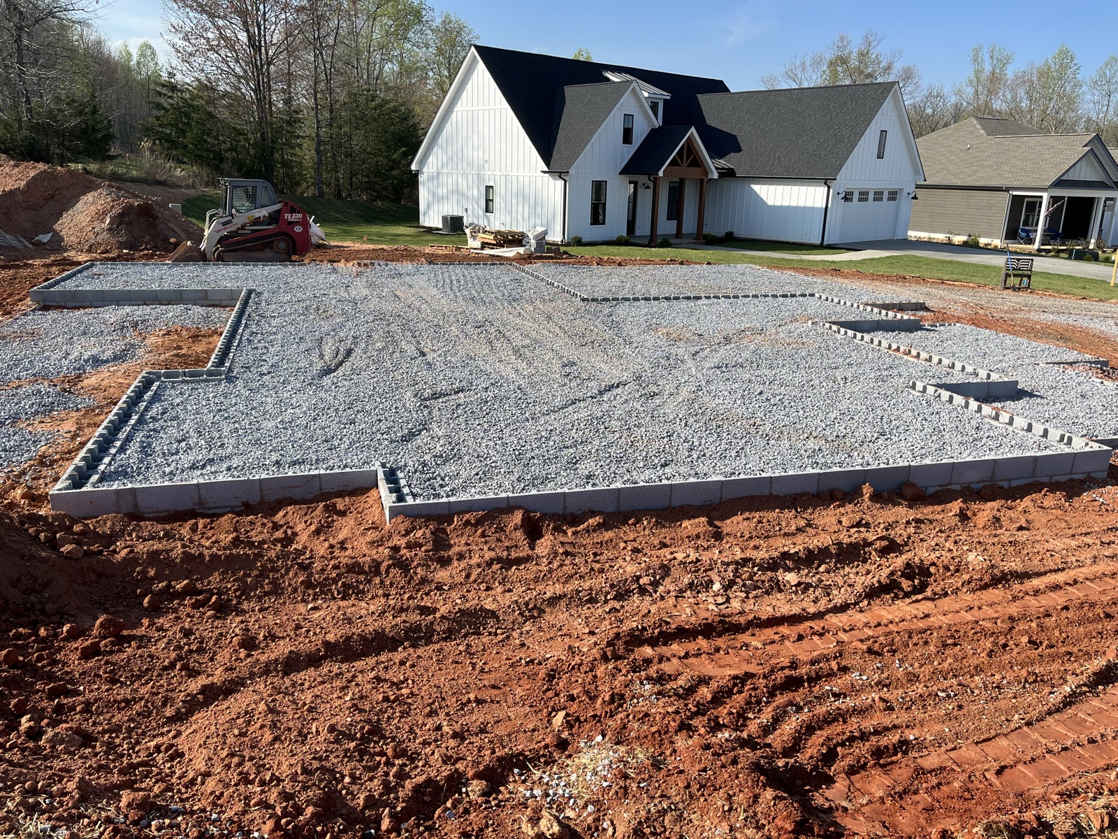 Compacted gravel foundation base for a new home on a hillside lot