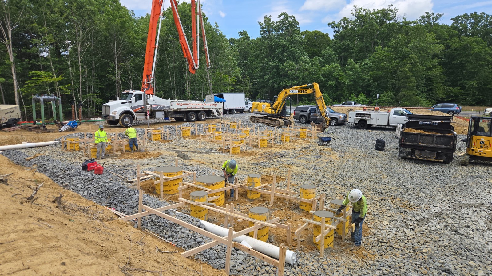 Concrete pump truck and rebar footing forms staged on an active Oxen Civil construction site