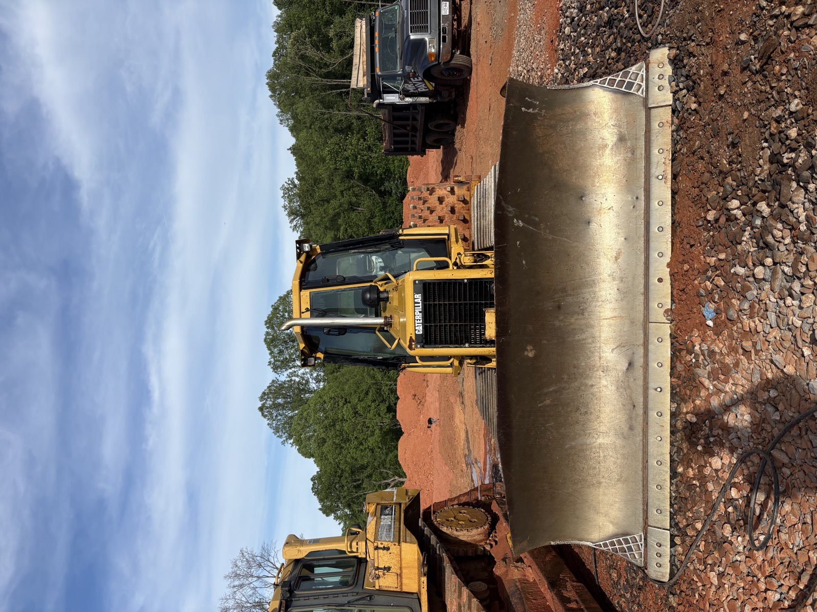 Oxen Civil dozer blade grading a red-clay commercial site near Lynchburg, VA