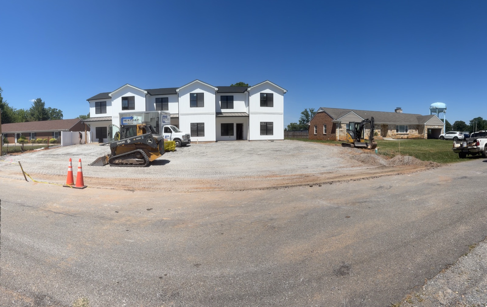 Freshly graded commercial lot ready for a new building, with dozer staged on-site