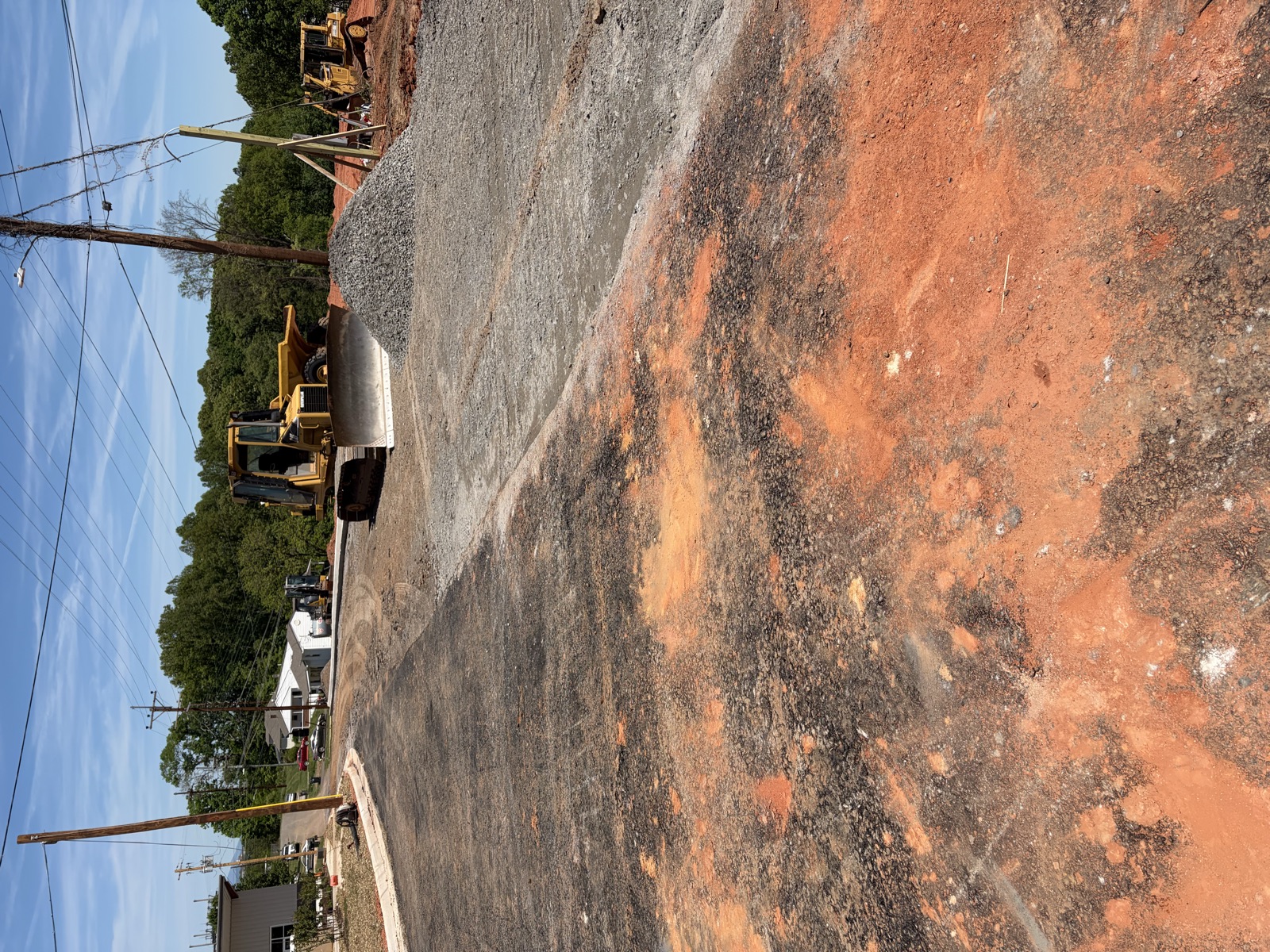 Oxen Civil dozer and gravel stockpile grading a subdivision street