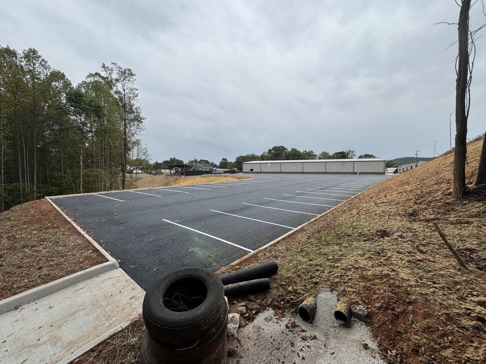 Finished commercial parking lot with fresh asphalt and new painted striping